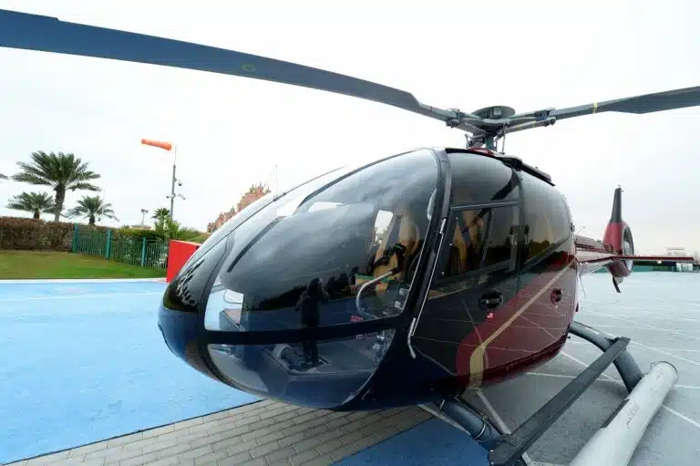 Sightseeing helicopter on the helipad with Atlantis in the background