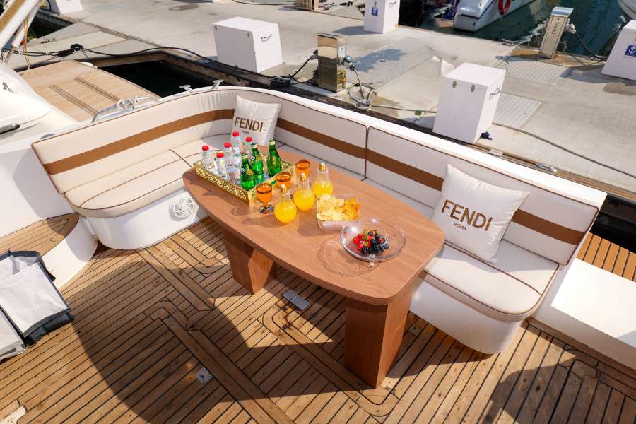 Outdoor seating and table on the aft deck of the 55-foot yacht