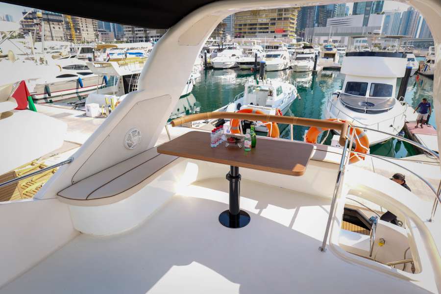 Upper deck seating aboard the 55-foot yacht in the marina